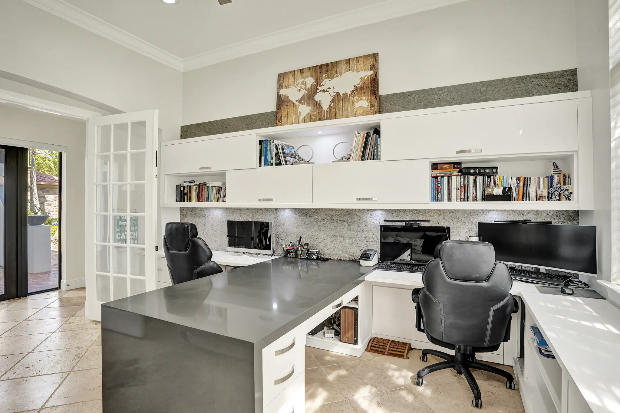 Home office — full wall built-in cabinetry & dual monitors